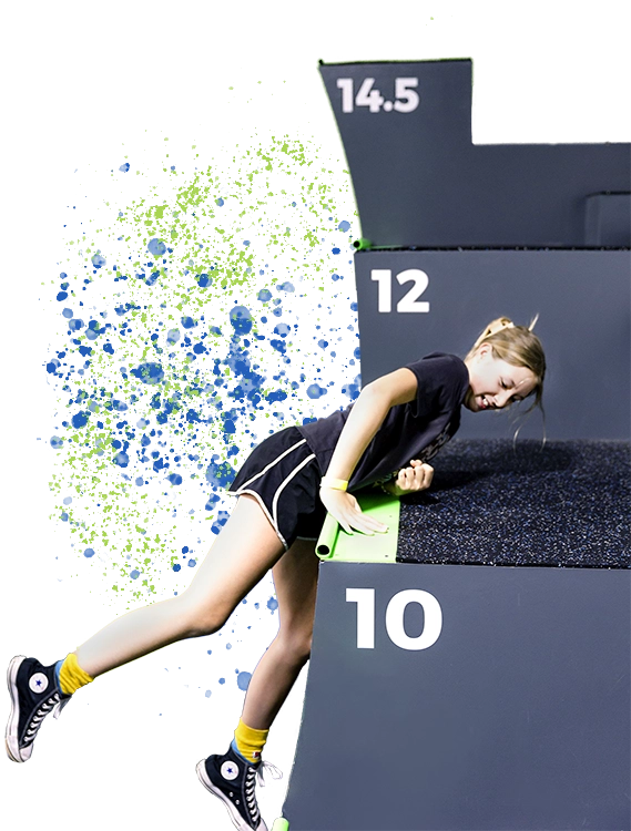 Girl doing an elbow plank on a low step obstacle with a green pad; steps marked 10 & 12.